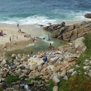 Portheras Cove - People bathe where the stream meets the sea.