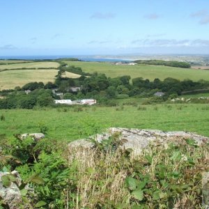 A view over the hedgerow from the road to Trencrom village