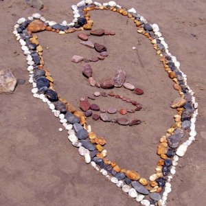 Creation of beach art at Long Rock