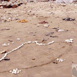 Creation of beach art at Long Rock