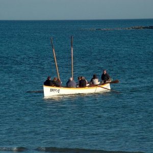 Gig team rowing in front of St Michaels