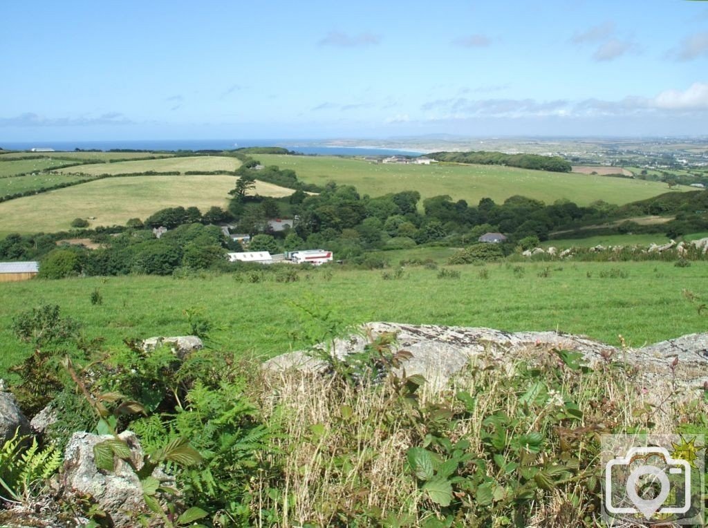 A view over the hedgerow from the road to Trencrom village