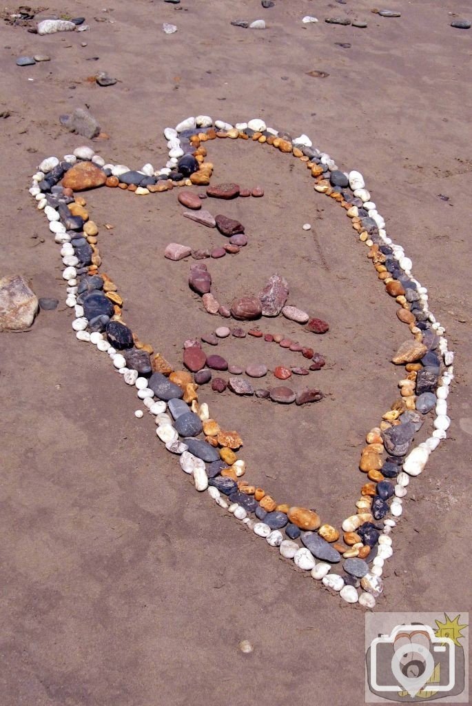 Creation of beach art at Long Rock