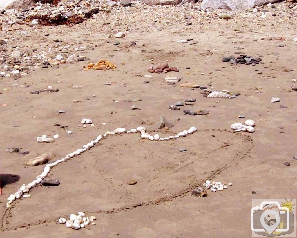 Creation of beach art at Long Rock