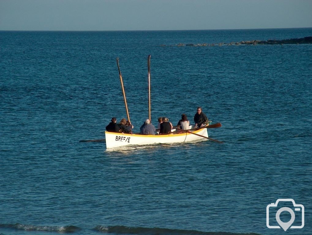 Gig team rowing in front of St Michaels