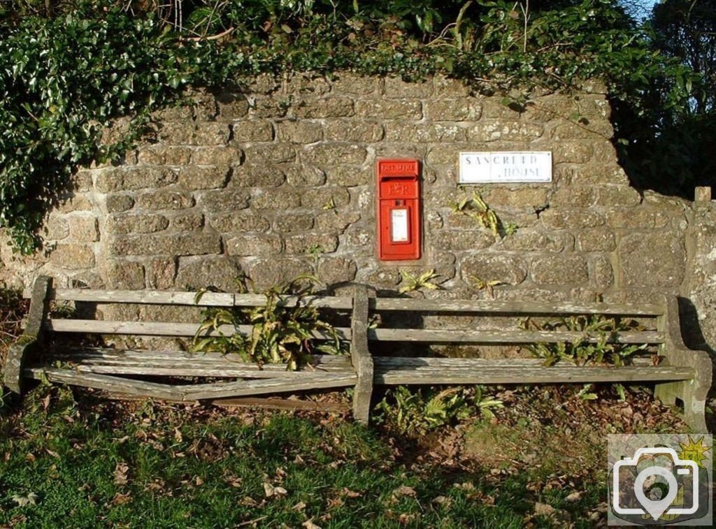 Letter Box near Church and a rickety public bench