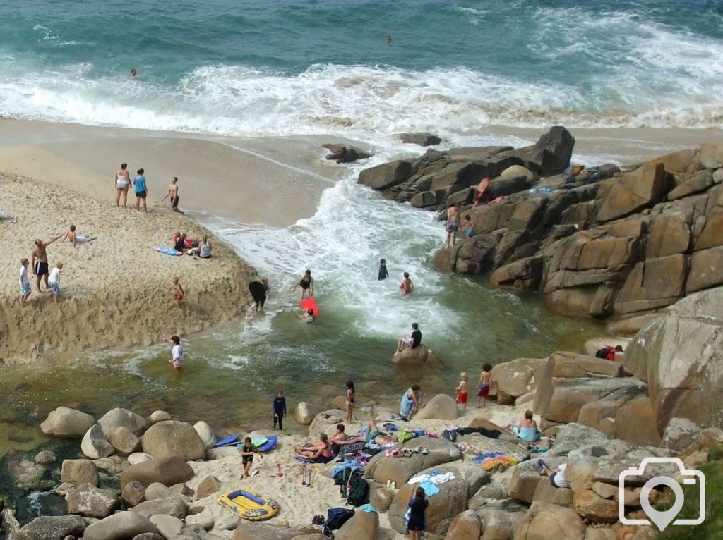 Portheras Cove - People bathe where the stream meets the sea.