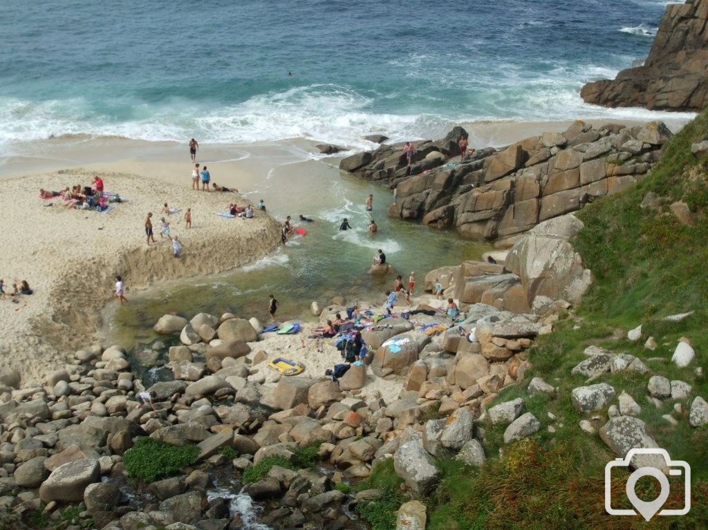 Portheras Cove - People bathe where the stream meets the sea.