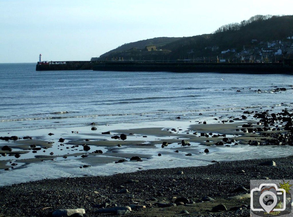 View across the shore to Newlyn's harbour lighthouse